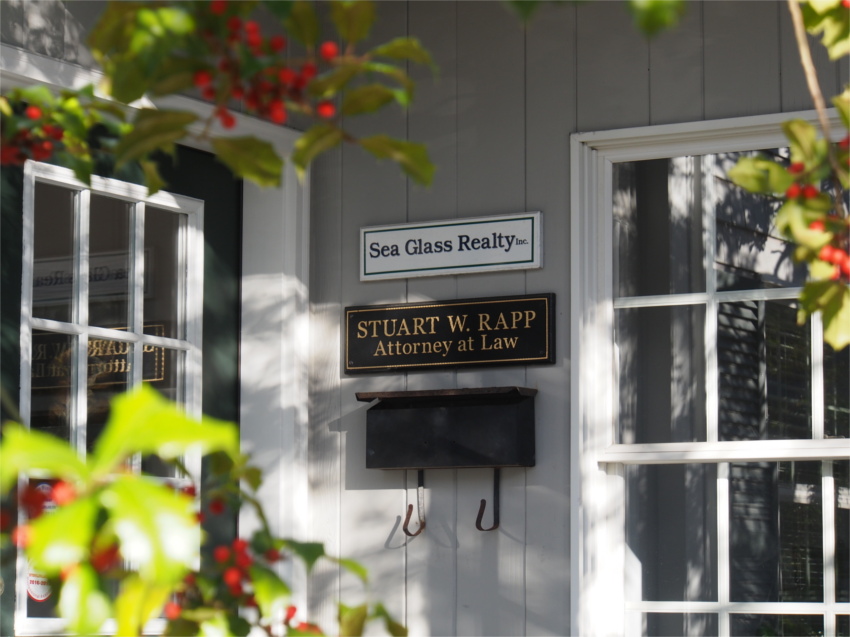 Stuart Rapp Attorney and Sea Glass Realty signs on building
